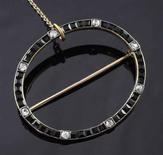 A 1920s/1930s gold, black onyx and diamond open brooch, 1.75in.